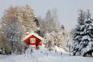 little red-cottage surrounded by snow and ice, winter scenery typical of sweden