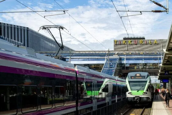 Vantaa, Finland - June 26. 2019 - Tikkurila train station. People getting on the train, two trains on the platform